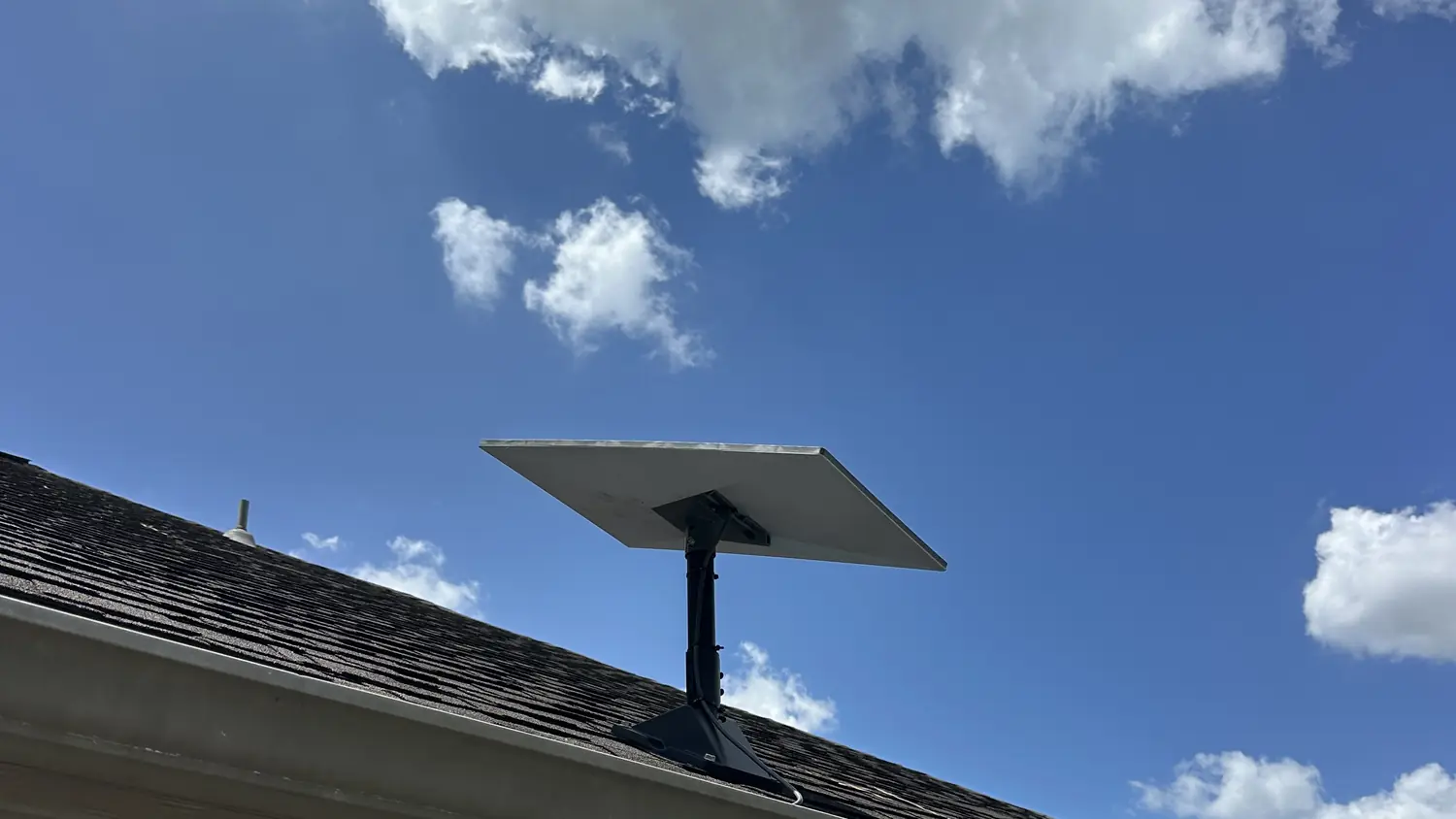 Starlink dish on a roof mount under a blue Central Texas sky