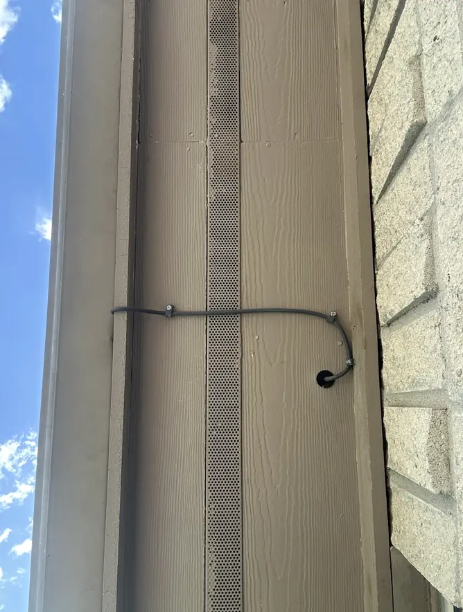 Starlink cable run neatly along exterior trim, with a drip loop where it enters the wall