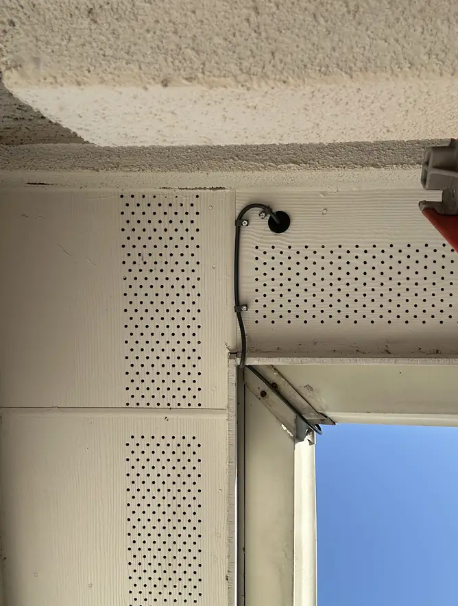 Starlink cable entering the house through the soffit under the eave