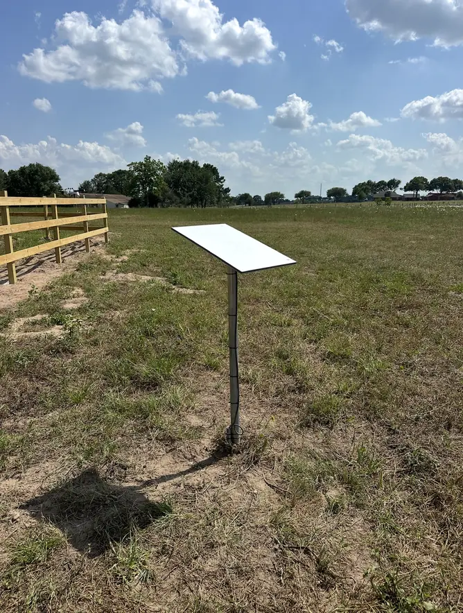 Starlink dish on a ground pole mount in an open pasture