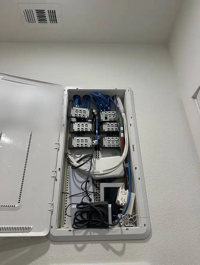 Hidden Starlink cable routing ending at a neatly wired network panel